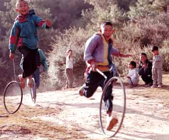 Children playing with their hoops in Bhutan, photograph: Jill Mead/Axiom